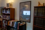 Reflected in a Jewish educational poster, Avery Barron gestures as she leads the conversation about Deuteronomy.