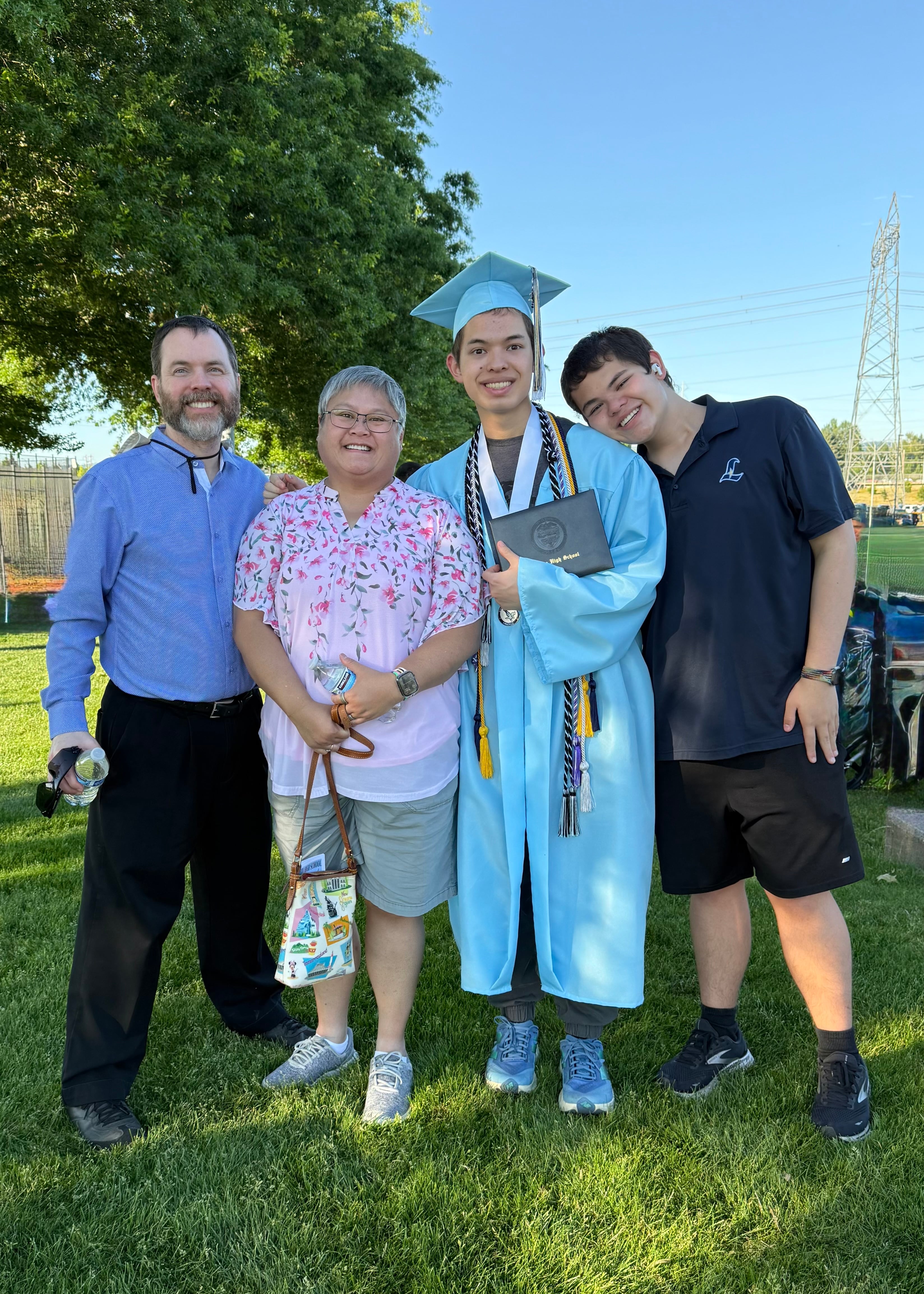 Kal Sibbel, a Liberty High School valedictorian, center, poses with his family at his graduation ceremony on June 7, 2025, in Hillsboro, Ore.