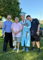 Kal Sibbel, a Liberty High School valedictorian, center, poses with his family at his graduation ceremony on June 7, 2025, in Hillsboro, Ore.