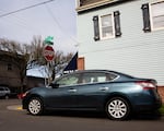 A car sits parked next to a crosswalk in Southeast Portland, Ore., Saturday, Feb. 22, 2020. A $5.9 million lawsuit claims Portland knowingly ignores Oregon law by allowing drivers to park too close to crosswalks and intersections.