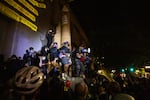 Mac Smiff (with megaphone) speaks to a crowd gathered at the Multnomah County Justice Center in Portland, Ore., July 22, 2020. Smiff says protests remain about the local budget, defunding police and standing up for Black lives.