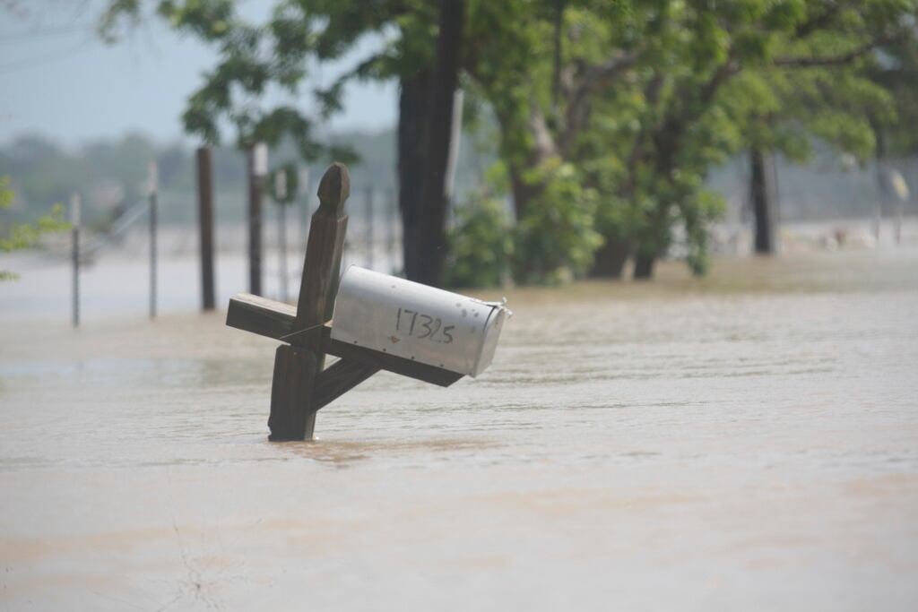 A mailbox is partially submerged on a flooded street in an unincorporated area in east Harris County near Houston on Sunday morning, May 5, 2024. The nearby San Jacinto River, overflowing due to heavy rainfall earlier this week, caused the flood waters.