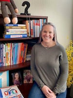 Reading expert Barbara Steinberg leans on a bookshelf at her office in West Linn. Steinberg trains teachers on systematic, explicit phonics instruction, an approach increasingly backed by research and brain science.