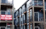 A 'Now Leasing' sign hangs off an apartment building staircase in southeast Portland, Ore., on Wednesday, Dec. 9, 2021. As of October, the most recent data provided by the U.S. Census Bureau, more than 67,000 Oregon households reported that they felt "not at all confident" that they would be able to cover the next month's rent. (AP Photo/Sara Cline)