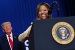 President Donald Trump listens as Nicki Minaj speaks during a campaign rally at McMorran Place Sports and Entertainment Center, Sunday, Oct. 25, 2026, in Port Huron, Mich.