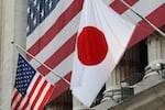 The flag of Japan (right) hangs outside the New York Stock Exchange on May 5, 2008, in honor of Ryozo Kato, the ambassador of Japan to the United States at the time, ringing the opening bell.