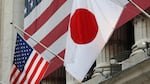 The flag of Japan (right) hangs outside the New York Stock Exchange on May 5, 2008, in honor of Ryozo Kato, the ambassador of Japan to the United States at the time, ringing the opening bell.