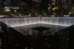 This photo, taken after dark, shows one of the twin reflecting pools at the 9/11 Memorial in New York City on September 2, 2026. The square pool sits in the footprint of one of the original World Trade Center twin towers. Water falls down the inner walls of the pool.
