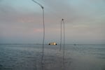 In California's Central Valley, a long-disappeared lake has been resurrected. A power line dangles precariously over the edge of the water now filling the Tulare Lake Basin, and a building on the horizon is caught in the middle of the flood.