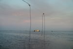 In California's Central Valley, a long-disappeared lake has been resurrected. A power line dangles precariously over the edge of the water now filling the Tulare Lake Basin, and a building on the horizon is caught in the middle of the flood.