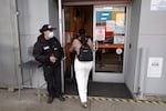 A security guard stands in front of the St. John’s Community Health clinic in South Los Angeles.