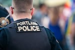 A Portland police officer photographed from behind.