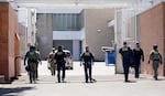 Department of Homeland Security officers protect the driveway of the U.S. Immigration and Customs Enforcement building in Portland, Ore., June 17, 2025. 