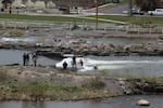 A team that designed the Bend Whitewater Park investigates the components of a surf wave on May 5, 2022, days after 17-year-old Ben Murphy died after he was trapped underwater at the wave.