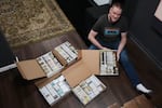 Brian Emerick poses with his recorded tapes for a photo at his home in Des Plaines, Ill., Thursday, March 19, 2026.
