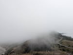 Fog wraps around a winding highway and coastal shoreline on Oregon's Yaquina Head in this provided photo from 2024. In a recent study, researchers used surfing webcams to better understand fog on the Oregon Coast.