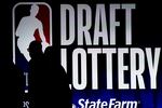 FILE - People walk by a sign during the NBA basketball draft lottery in Chicago, Tuesday, May 16, 2023. (AP Photo/Nam Y. Huh, File)