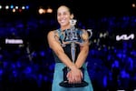 Madison Keys of the U.S. hugs the Daphne Akhurst Memorial Cup after defeating Aryna Sabalenka of Belarus in the women's singles final at the Australian Open tennis championship in Melbourne, Australia, Saturday, Jan. 25, 2025. (AP Photo/Asanka Brendon Ratnayake)