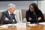 Fed Chair Jerome Powell speaks with Lisa Cook, a member of the Board of Governors of the Federal Reserve, during a meeting in Washington on June 25.