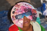 A beachgoer wearing special eclipse glasses looks up during the beginning phase of a solar eclipse at Puerto de Sagunto beach near Valencia, Spain, Wednesday, Aug. 12, 2026.