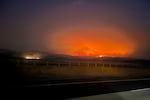 In this image provided by the Oregon Department of Transportation, the Durkee Fire burns in the background as it nears Interstate 84 near Huntington, Ore., early Tuesday, July 23, 2024.