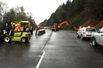 Crews work to clear debris and install temporary barriers to allow them to reopen one lane of Interstate 5 Dec. 10 after the entire northbound section of the highway was closed due to a Dec. 9 landslide. The interstate reopened two lanes the evening of Dec. 10.