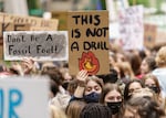 "This is not a drill," reads one of the many signs held by young people who marched through downtown Portland, May 20, 2022, demanding city leaders take action on climate change.