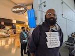 Standing inside an airport, Lee Collins waits for his flight back to Atlanta from Washington, D.C., on April 28.