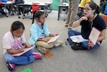 FILE - A teacher works with students on reading skills at Imlay Elementary School in Hillsboro, Ore., on Wednesday, July 31, 2024. Fourth-grade reading scores are one of the education indicators of well-being in the Kids Count Data Book.