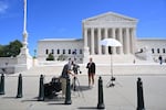 Broadcast journalists work in front of the U.S. Supreme Court in Washington, D.C., on Sept. 15. The new term begins on Monday.