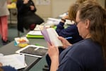 A student in PSU's new "Metamorphosis" class at Coffee Creek Correctional Facility looks through a journal back in October. The 15-credit general education course was offered for the first time this year -- because of COVID-19, the class is ending differently than it started.