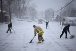 LOUISVILLE, KENTUCKY - JANUARY 5: Firefighters with Louisville Fire Department Quint 9 shovel snow in front of their station on January 5, 2025 in Louisville, Kentucky. Local forecasts called for heavy snowfall followed by significant accumulation of freezing rain and ice. (Photo by Luke Sharrett/Getty Images)