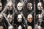 An array of masks is displayed for the Be Nice (White) You're In Bend exhibit at Scalehouse in Bend, Ore., Friday, Aug. 6, 2021. The masks symbolize how many Black, Indigenous and people of color feel they must mask who they really are in uber-white Bend.