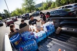 Members of the Social Club stack supplies to distribute to demonstrators in Happy Valley, Ore., Wednesday, June 3, 2020.