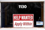 FILE - A "help wanted" sign is seen at an Allstate insurance office in Elgin, Ill., March 19, 2022.