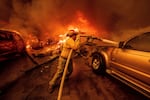 A firefighter battles the Eaton Fire on Wednesday, Jan. 8, 2025 in Altadena, Calif.