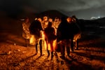 Immigrants from Ecuador warm themselves after crossing the U.S.-Mexico border on March 6, in Campo, Calif. Migrants from Ecuador, China, Georgia and other nations waited for U.S. Border Patrol agents to collect them to process asylum claims.