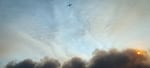 An air tanker flies above south Medford to drop fire retardant onto the Almeda Fire as it tore through residential neighborhoods on Sept. 8, 2020.