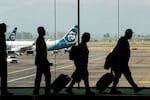 Passengers arrive at Portland International Airport in Portland, Ore., on Thursday, Nov. 13, 2025.