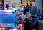 Shoppers stand outside Clackamas Town Center mall, Dec. 20 2024. The police response shut down the parking lot for several hours.