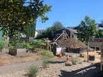 Construction crews erect the frames for two side-by-side houses on Northeast 74th Street, Portland, Ore., Aug. 2, 2022. The houses are part of an infill project where a single aging house was demolished earlier in the year.