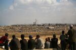 Palestinians look toward Gaza City from Nuseirat in the central Gaza Strip on Oct. 10, 2025. Gaza's civil defense agency said on October 10 that Israeli forces have begun pulling back from parts of the territory, particularly in Gaza City and Khan Yunis.