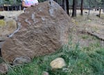A stone in the yard of Tim Flynn's home, commemorating his wife, Terry Ellis, who died from cancer in 2018. The Flynns had to leave many cherished possessions behind when they evacuated due to the Flat Fire on Aug. 22, 2025.