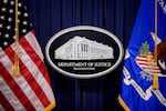 The Department of Justice logo is displayed before U.S. Attorney General Pam Bondi arrives for a news conference at the agency on May 6, 2025 in Washington, DC. The DOJ announced in a June memo that it is aggressively prioritizing efforts to strip some Americans of their U.S. citizenship.