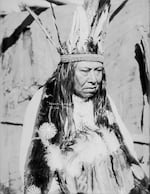 "Tuts-Homi? in Partial Native Dress with Headdress and Ornaments and Holding Headdress 1900"