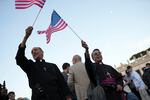Clerics wave US flags during the speech of the newly elected Pope Leo XIV at the Vatican, Thursday, May 8.