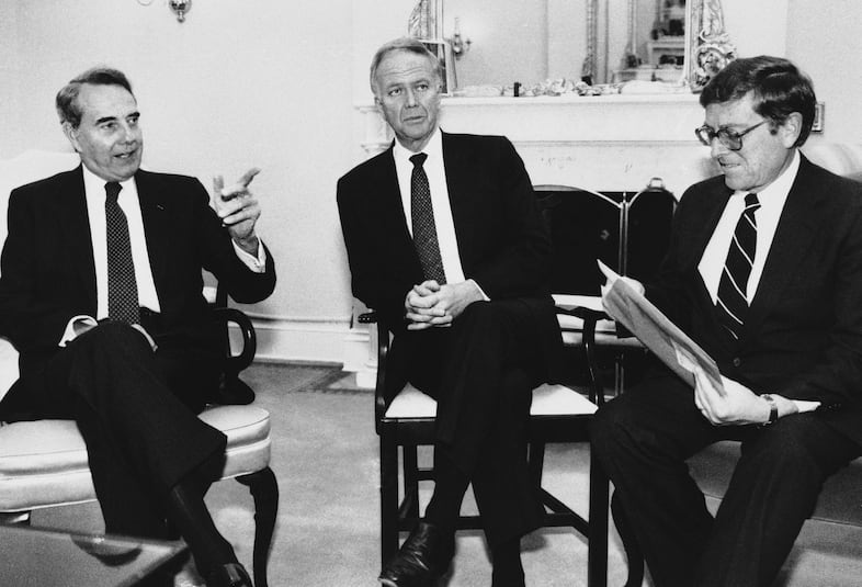 Senate Majority Leader Robert Dole of Kansas, left, speaks with Sen. Bob Packwood, R-Ore., and Senate Budget Committee Chairman Sen. Pete Domenici, R-N. Mex., right, about pending budget legislation on Capitol Hill, Tuesday, Nov. 12, 1985, Washington, D.C.