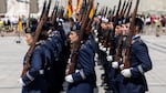 German soldiers wearing navy blue uniforms and carrying rifles stand in three rows during a ceremonial roll call on May 22, 2025, in Vilnius, Lithuania.