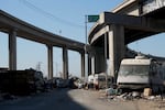 Abandoned camper and tents under and overpass in Oakland, California.