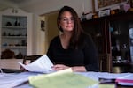 Oregon state Sen. Sara Gelser, D-Corvallis, pores over documents related to the state's foster care crisis at her dining room table in Corvallis, Ore., Monday, Nov. 11, 2019.